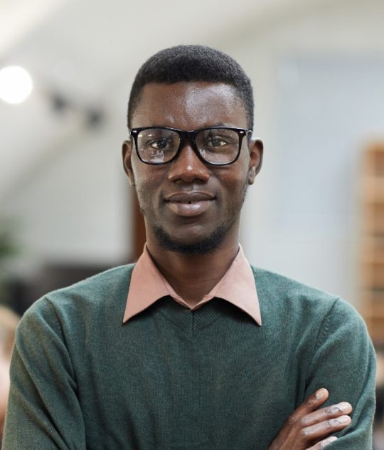 african-businessman-posing-in-office-PWUARZ8.jpg